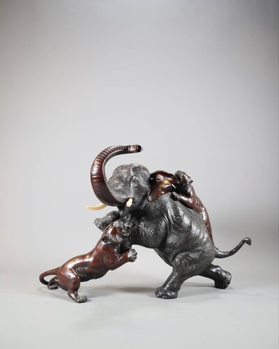 A Japanese bronze group of an elephant and tigers. Meiji period Height 32cm, width 48cm